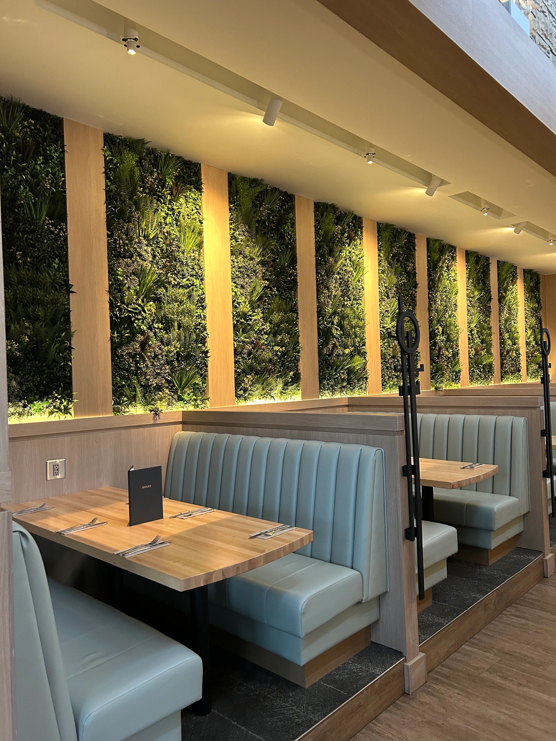 Custom millwork installation with wood wall panels and cabinetry in Regina, SK.