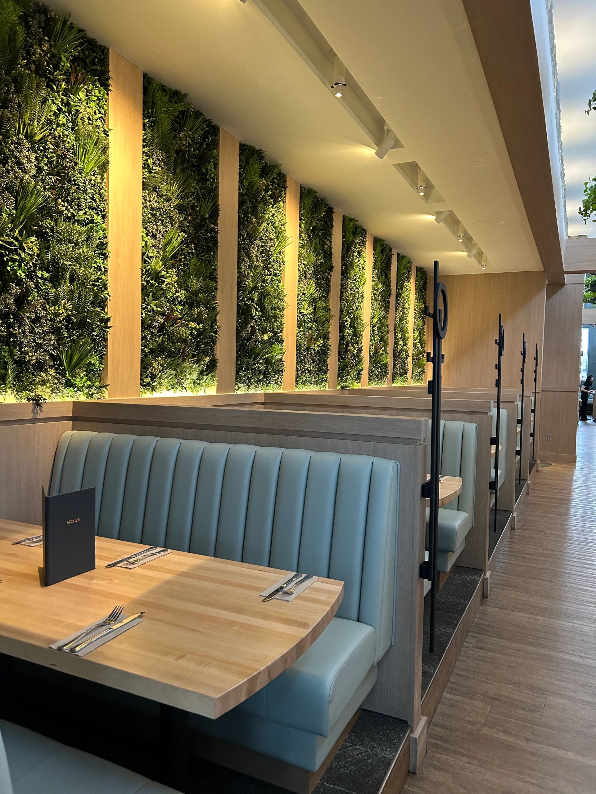 Custom millwork installation with wood wall panels and cabinetry in Regina, SK.