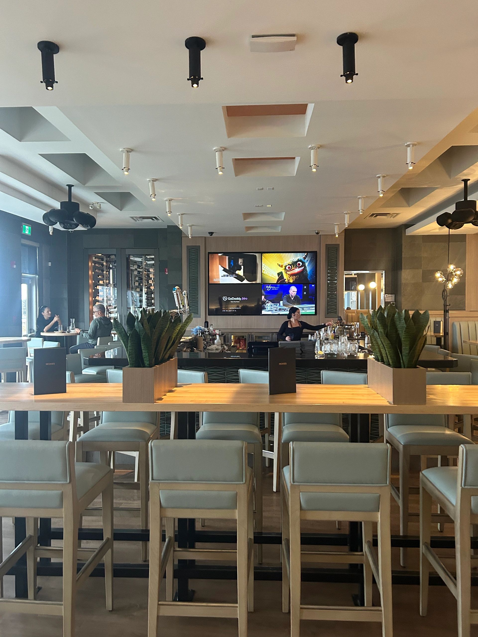 Custom millwork installation with wood wall panels and cabinetry in Regina, SK.