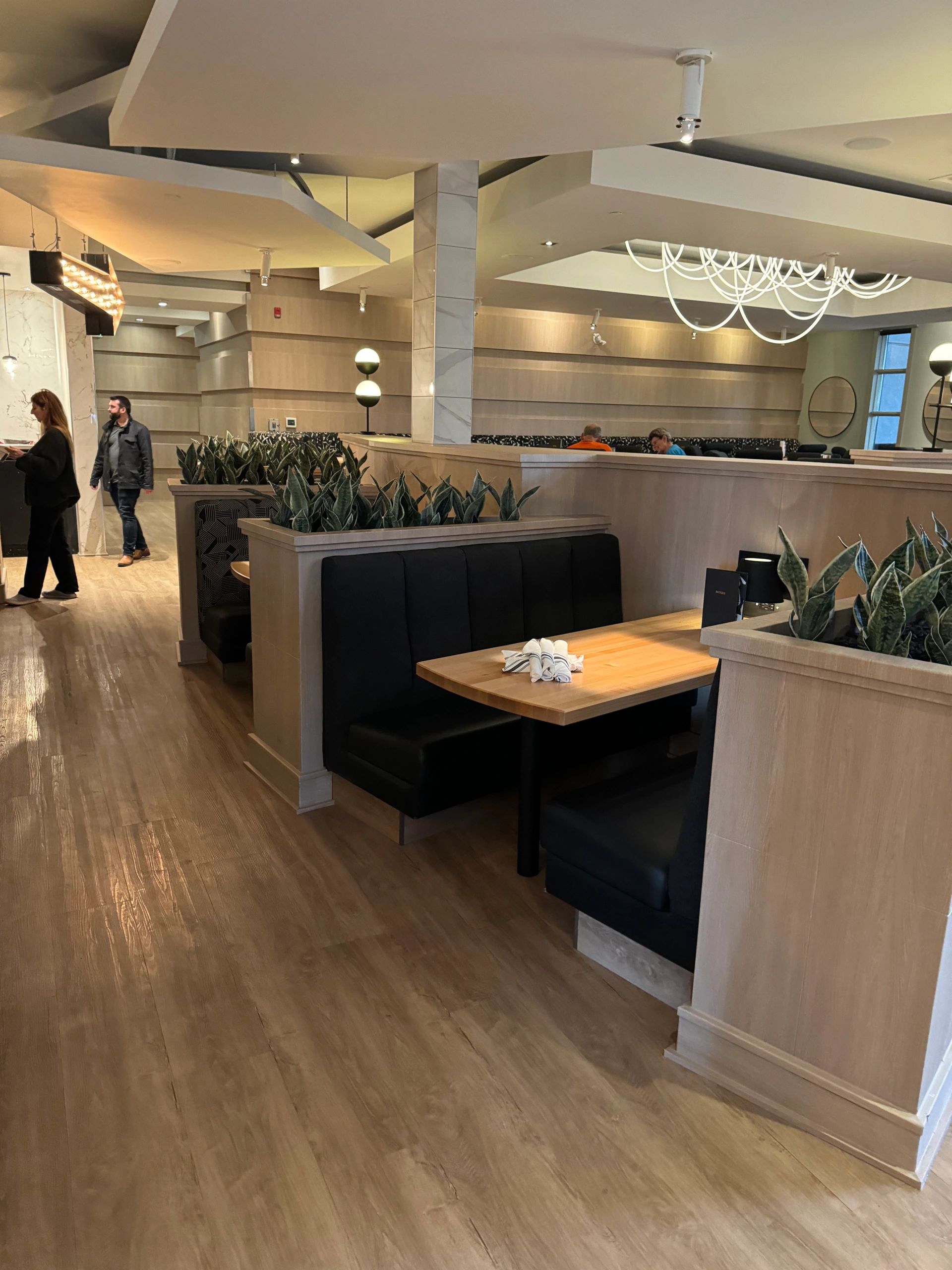 Commercial millwork installation with cabinetry and wood wall features in Calgary, AB.