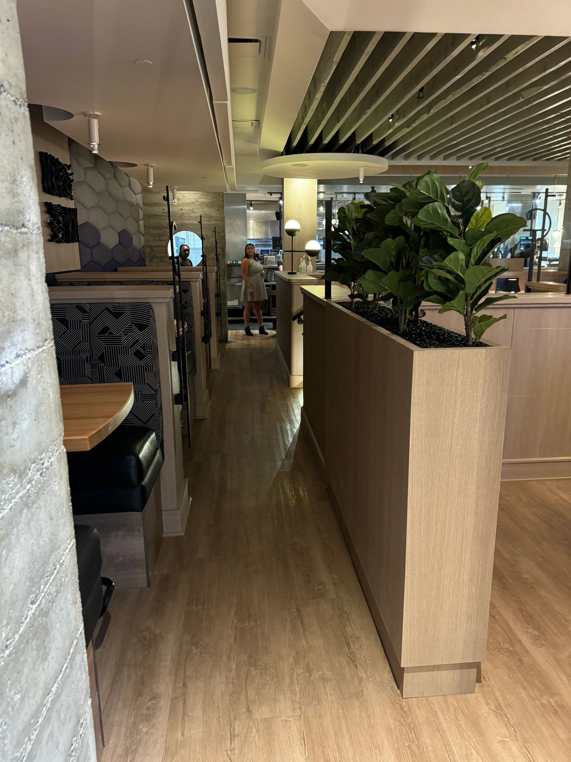 Commercial millwork installation with cabinetry and wood wall features in Calgary, AB.