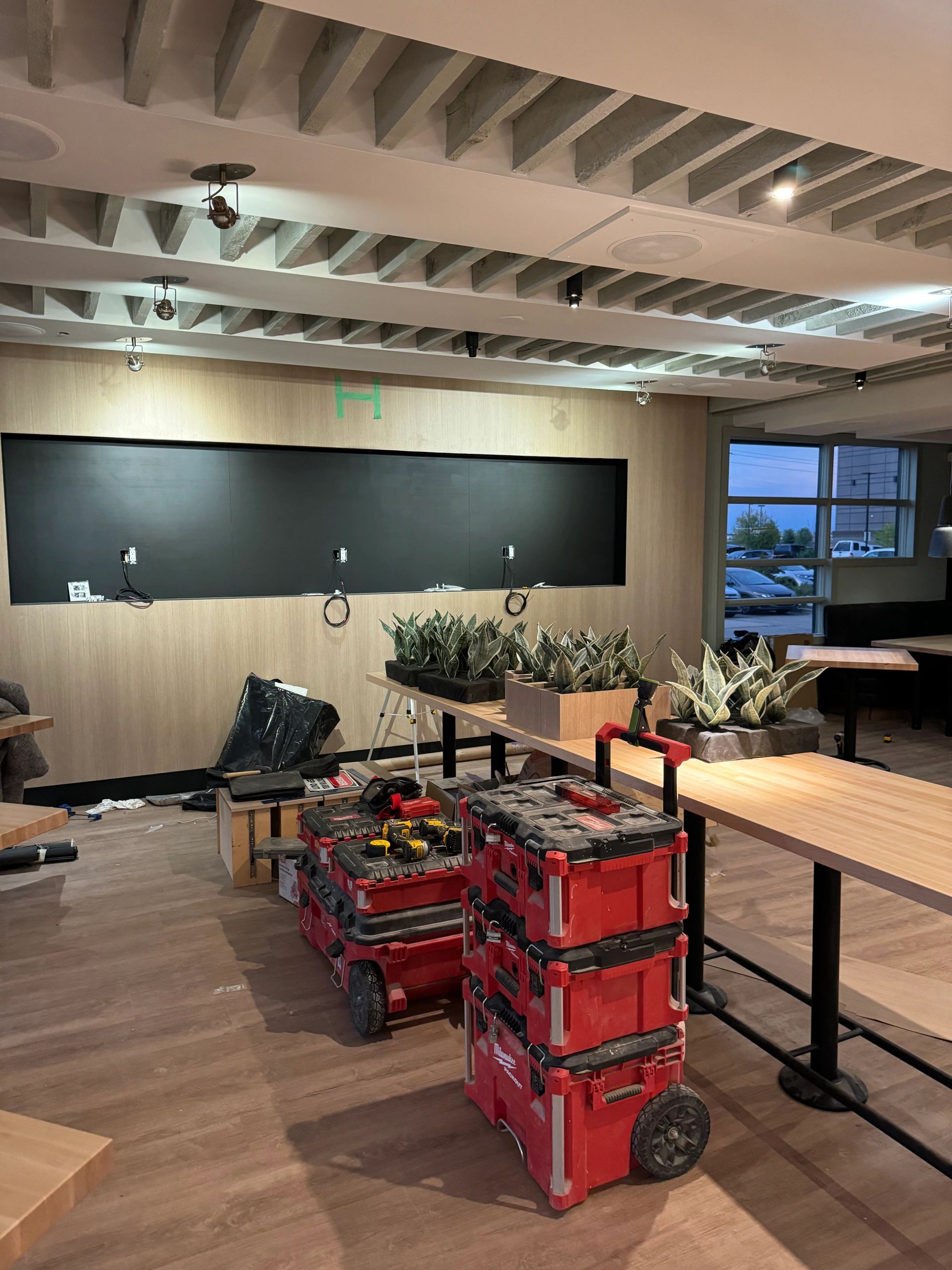 Commercial millwork installation with cabinetry and wood wall features in Calgary, AB.