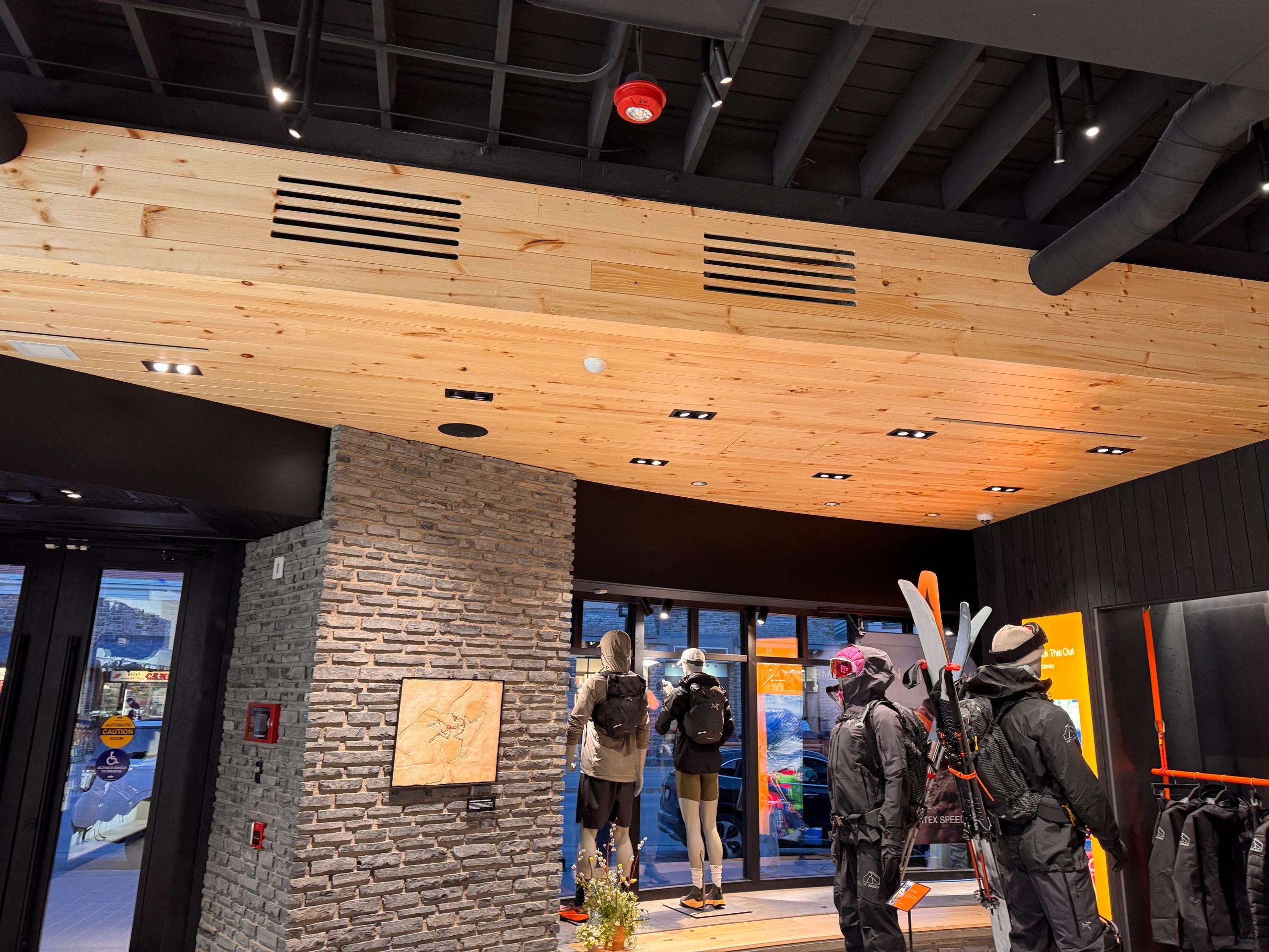 Custom millwork installation with wood wall panels and cabinetry in Banff, AB.