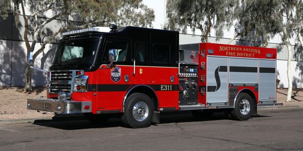 A red and black Northern Arizona fire truck parked on a street.