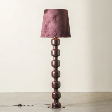 Tall floor lamp with a purple velvet shade and stacked rounded base.