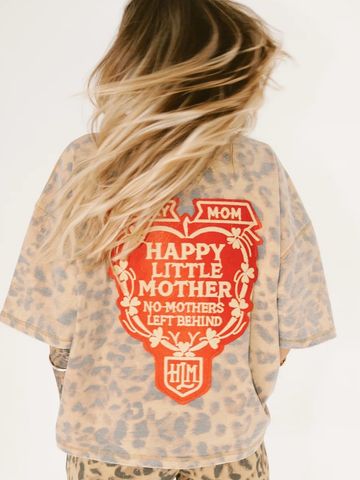 Person wearing a leopard print shirt with a red and white mother-themed graphic on the back.