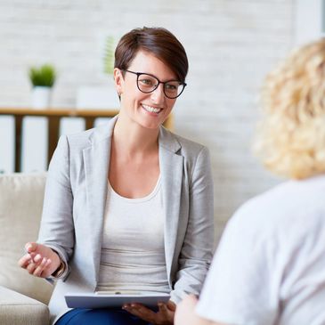 Psychiatric Mental Health Nurse Practitioner meeting with one of her clients