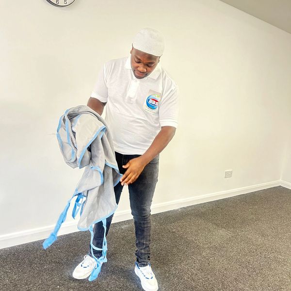A man carrying a patient's clothes