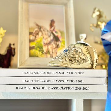 Silver equestrian trophy hat on Idaho Sidesaddle Association books.