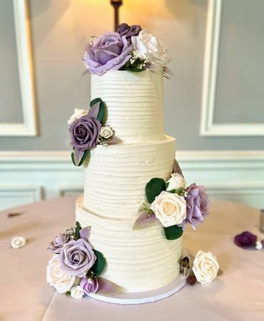 3-Tier White Wedding Cake with Palette Knife Design and Matching Floral. Lilac and White Roses.