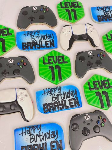 Gaming Themed Birthday Cookies with game controllers and blue, and green accents. 