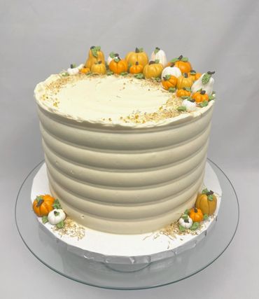 Pumpkin Themed Cake with Ivory Base and Combed Design. Topped with Handmade Edible Pumpkins.