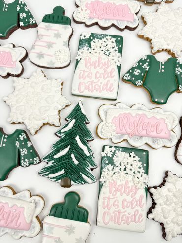 Baby It's Cold Outside Baby Shower Cookies with Snowflakes, Onesies, Christmas Trees, and Bottles.