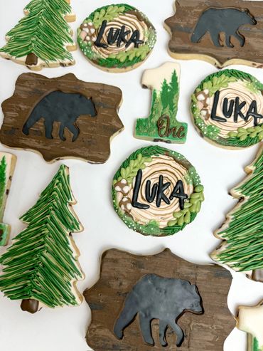 One Wild Cub Birthday Cookies with earthy tones. Bear silhouettes, Treesm, Age, and Stump with Name
