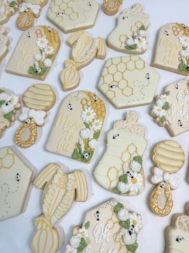 A Little Honey Is On The Way Baby Shower Cookies with Rattles, Onesies, Bottles, and "Oh Baby."