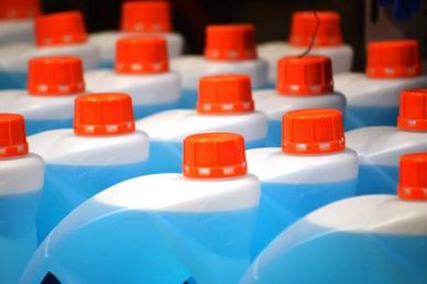Rows of blue plastic containers with orange caps.