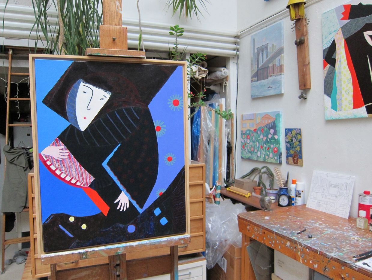 Colorful abstract painting on an easel in an artist's studio.