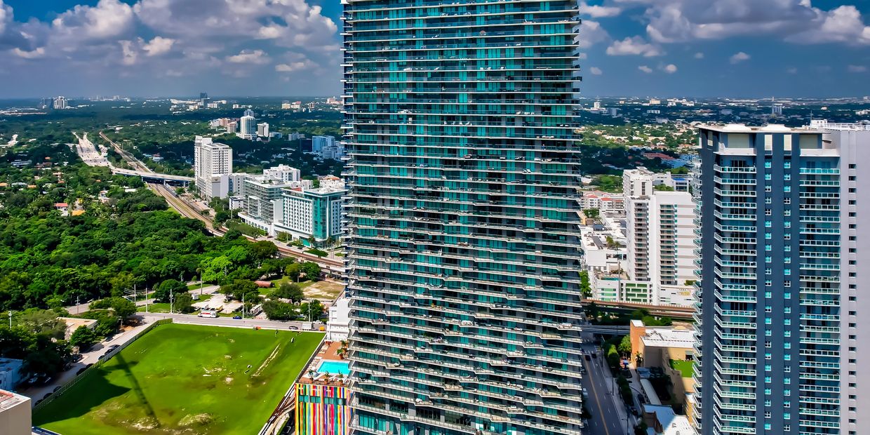 Aerial drone photograph of a Miami residential tower and park