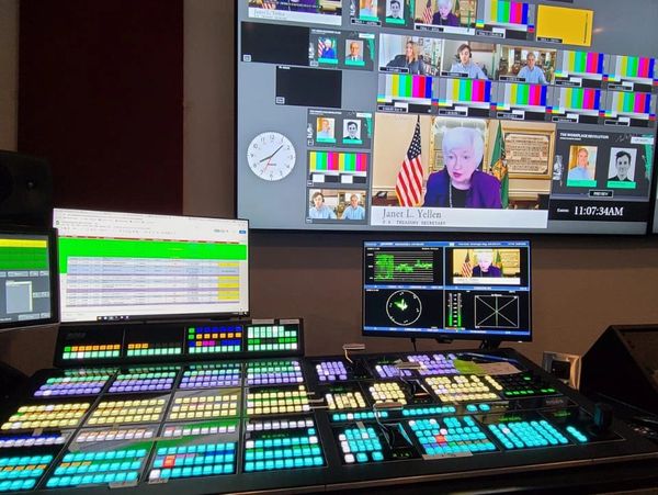 Broadcast control room with multiple screens showing Janet L. Yellen during a live session.