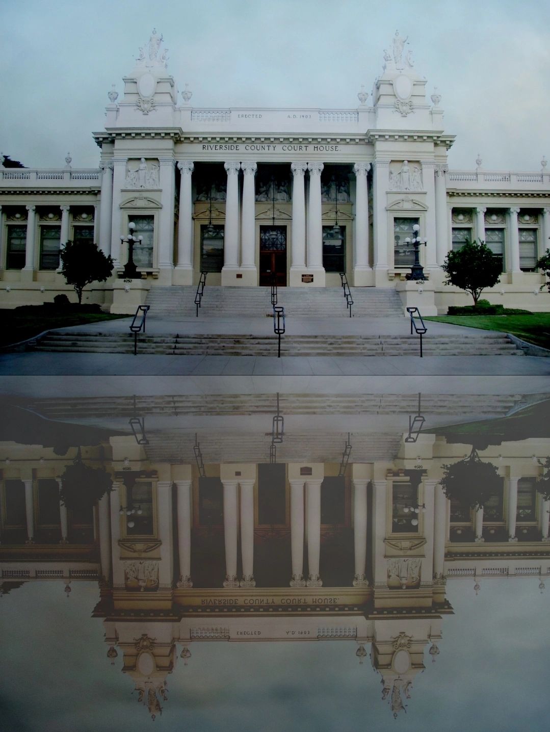 Riverside County Court House with its reflection in water.