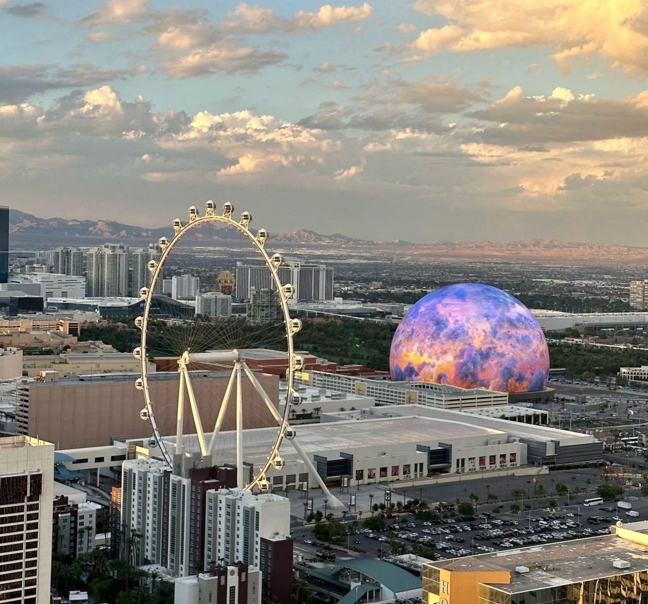 Las Vegas skyline with the High Roller Ferris wheel and a colorful dome structure.