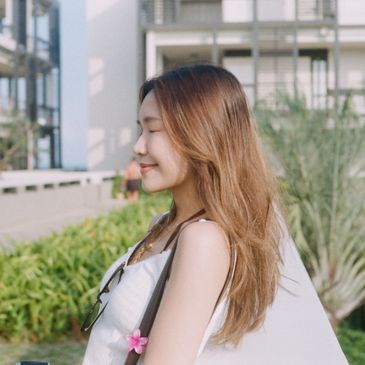 Young woman with long hair enjoying a sunny day outdoors.