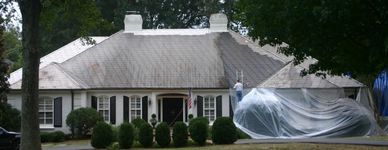 Asbestos roof being cleaned and repaired