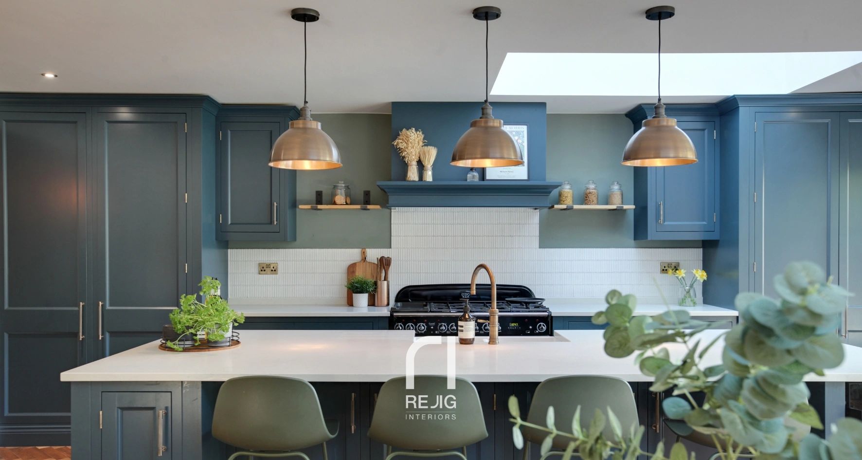 Modern kitchen with blue cabinets and white countertops.
