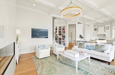 Bright and cozy living room with white furniture.