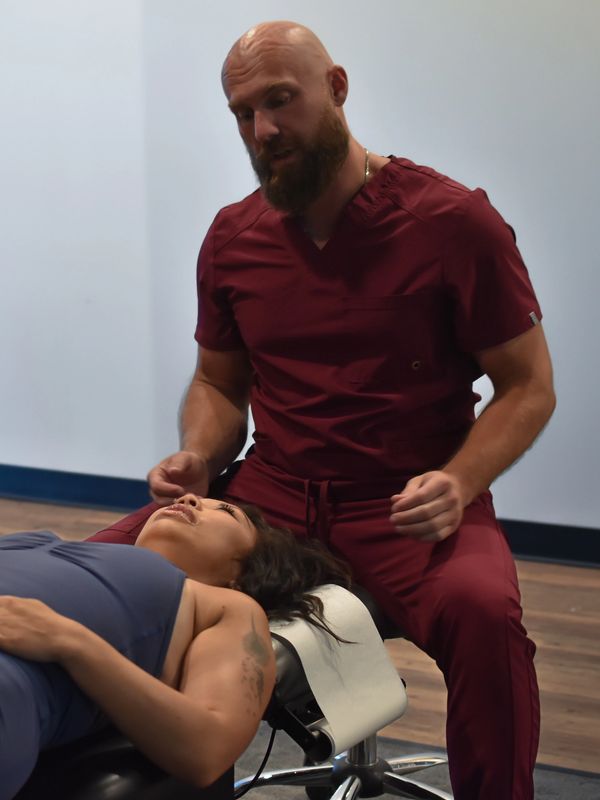 Chiropractor examining patient's neck.