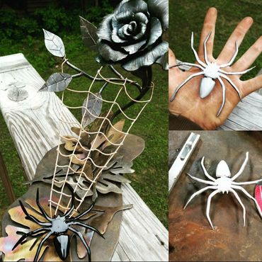 This is a hand forged flower with a copper spider web and a handmade steel spider