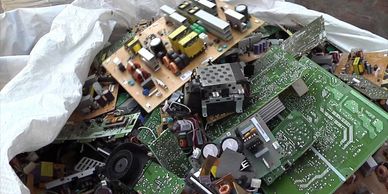 A pile of discarded electronic circuit boards and components.