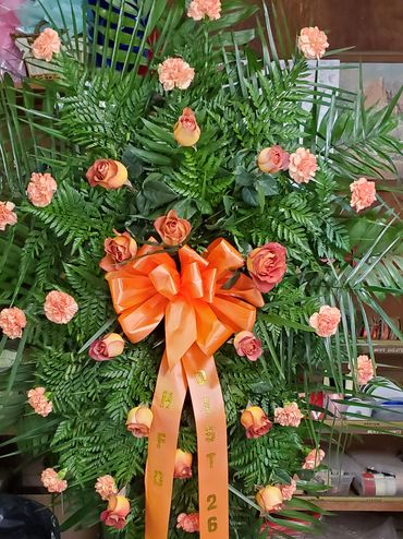 Arrangement created on a Standing easel Peach & Coral roses and carnation