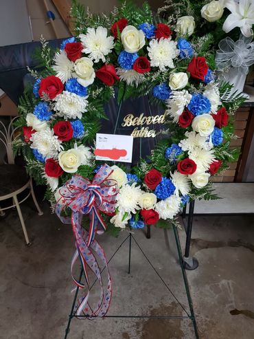 As shown, Mixed Floral Wreath Patriot Themed with  red and white roses, white spider mums & carnatio