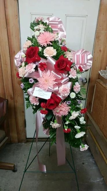 Standard 18 " sized small Hybrid Cross wrapped in satin ribbon with the addition of a fresh floral 