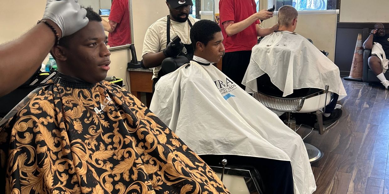 Students in training cutting hair in a school 