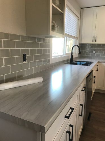 Finished kitchen with beautiful wooden cabinets, with black accents.