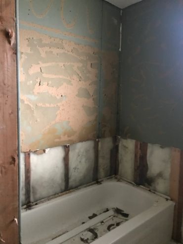 Removing an old bathtub.