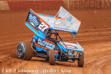 Sprint car racing on dirt track.