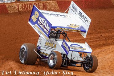 Sprint car racing on dirt track.