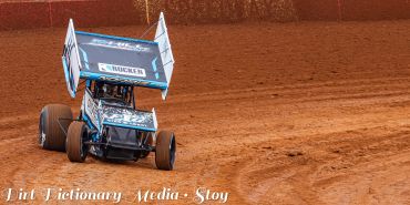 Sprint car racing on a dirt track.