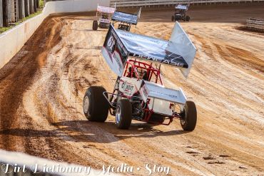 Sprint car racing on a dirt track.
