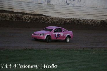 Pink race car number 17 on a dirt track during a race.