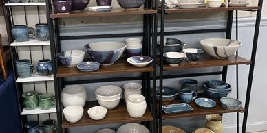 shelf full of a variety of pots