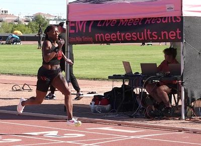 woman to cross finish line in front of timing tent at 2024 Nevada Senior Games. Photo by Tim Dorman