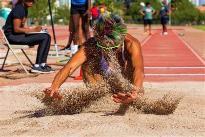 sand flies as athlete lands her long jump at 2024 Nevada Senior Games. Photo courtesy Julie Baker