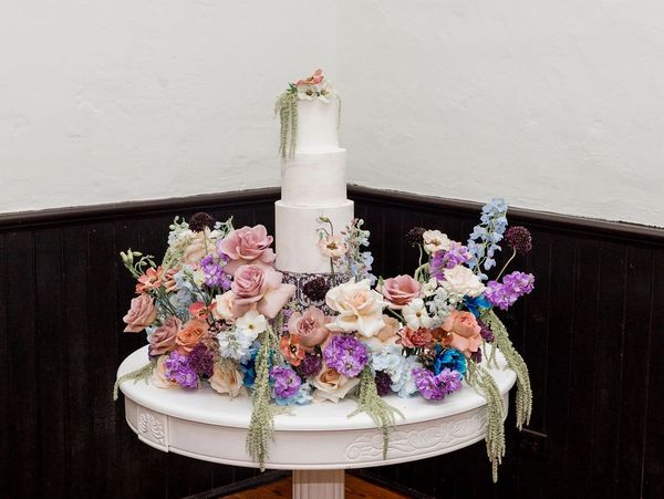 Cake on table surrounded by Flowers

Bronston Photography