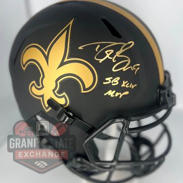 Signed New Orleans Saints football helmet with gold fleur-de-lis logo.