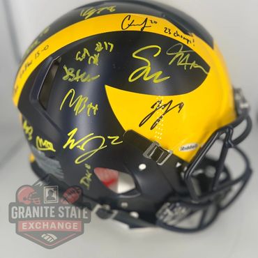 Black and yellow football helmet with multiple yellow autographs.