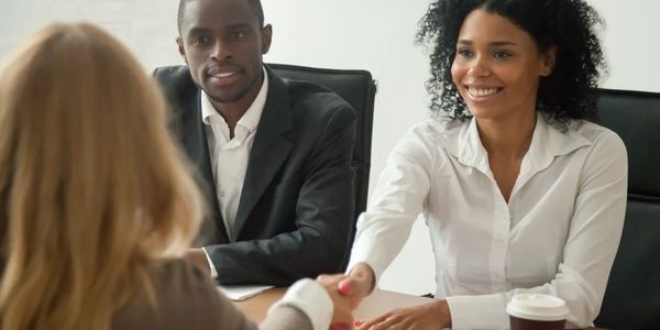 Two professionals shaking hands during a business meeting.